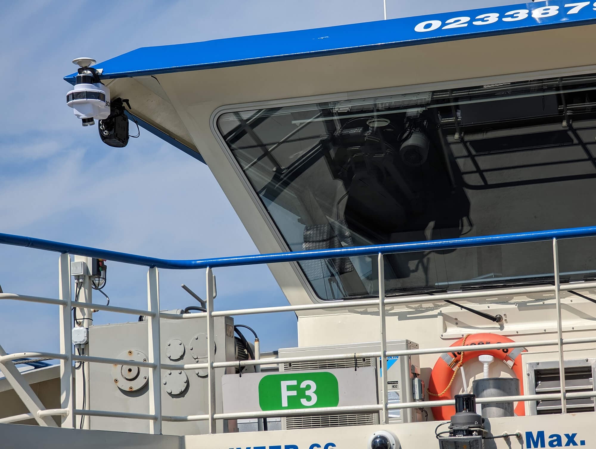 A GVB IJ ferry fitted with Roboat's sensor mast on the Amsterdam waterfront.