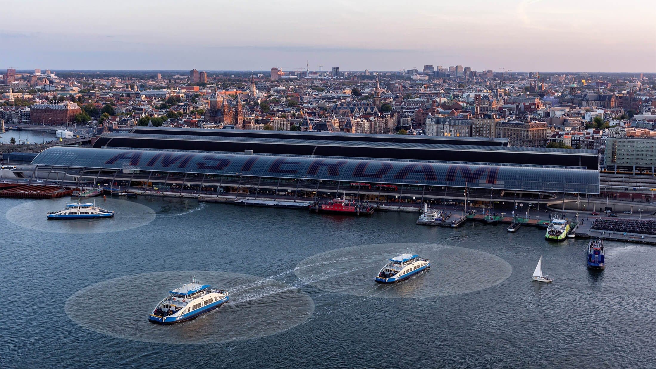 GVB IJ ferries crossing the IJ waterway in Amsterdam at dusk